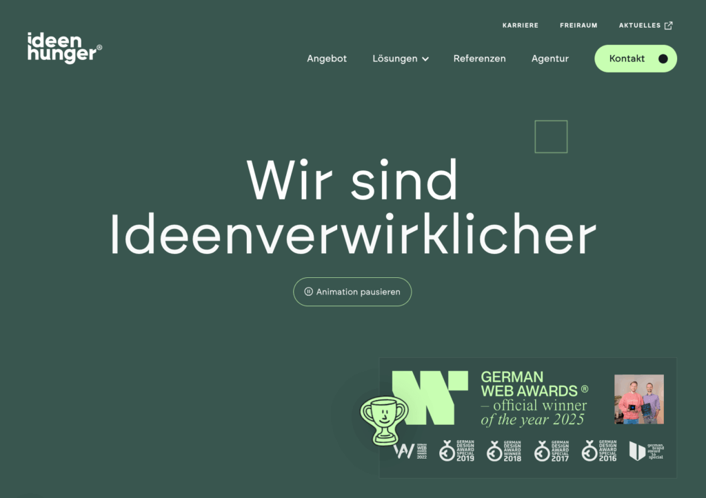 Ideenhunger Website zeigt 'Wir sind Ideenverwirklicher' mit Navigation, Animation-pausieren Button und German Web Awards